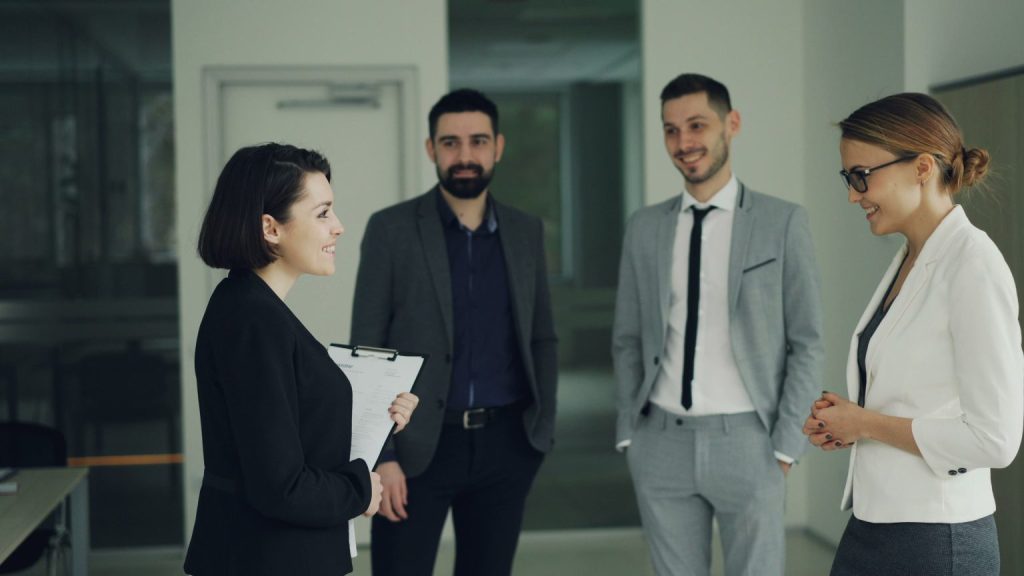 Group of professionals discussing strategy in a modern office setting.